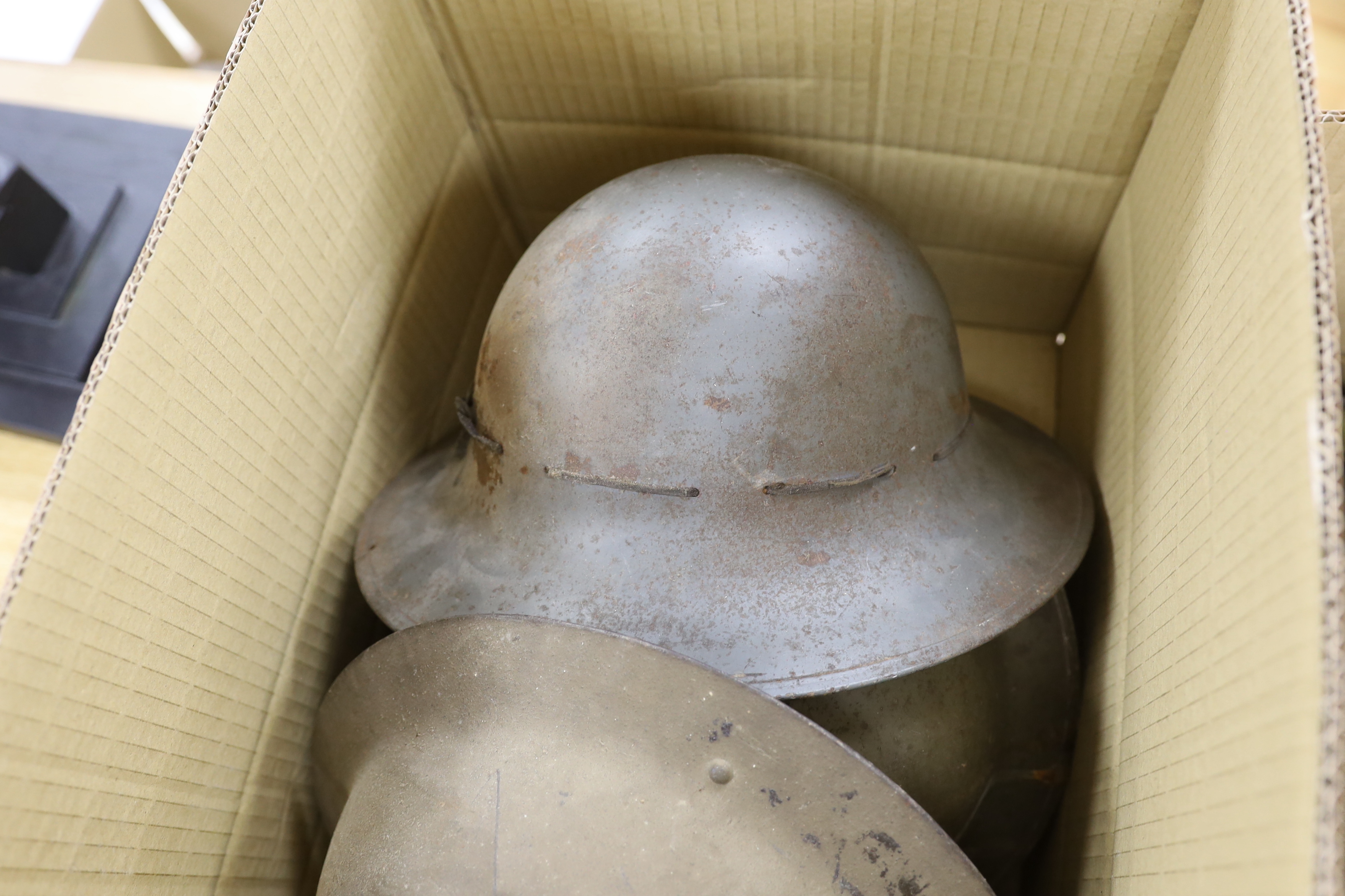 Six military etc. tin helmets. Including an example, painted as an Air Raid Warden’s helmet, with other items, including a military shoulder bag etc.